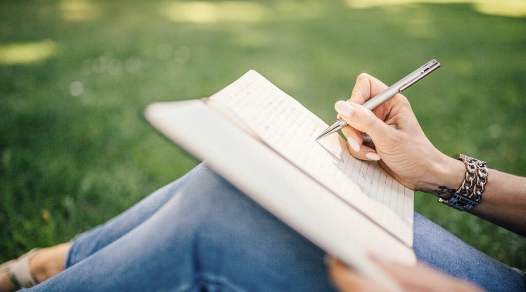 Person writing with a ballpoint pen 