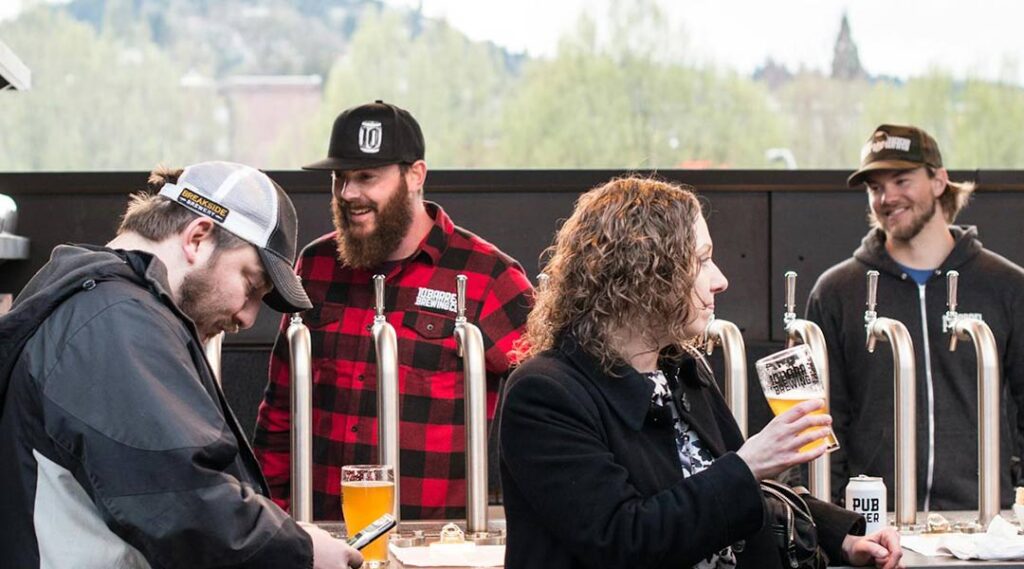 People wearing branded caps at an outdoor event 