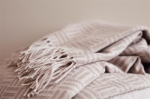 Geometric, patterned promotional blanket made of acrylic light brown colour