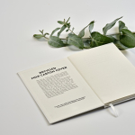 A5 hardback notebook made from recycled milk cartons with dotted pages white colour ambient view