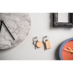 Round keyring in natural beech wood with metal ring still life view