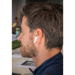 Wireless earphones with bamboo lid and 5 hours of battery life still life view