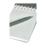 Mini spiral-bound notebook with black ink pen marbled green colour close-up view 2