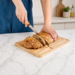 Grooved bamboo bread cutting board with included knife still life view