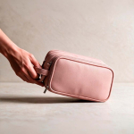 Hanging recycled synthetic leather toiletry bag with hook and three compartments pink colour