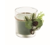 Candle in glass candleholder with festive forest decorations colour green