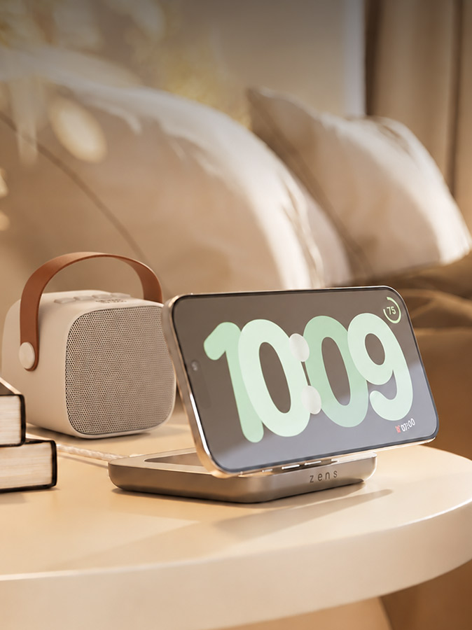 Wireless phone charging stand beside a portable speaker
